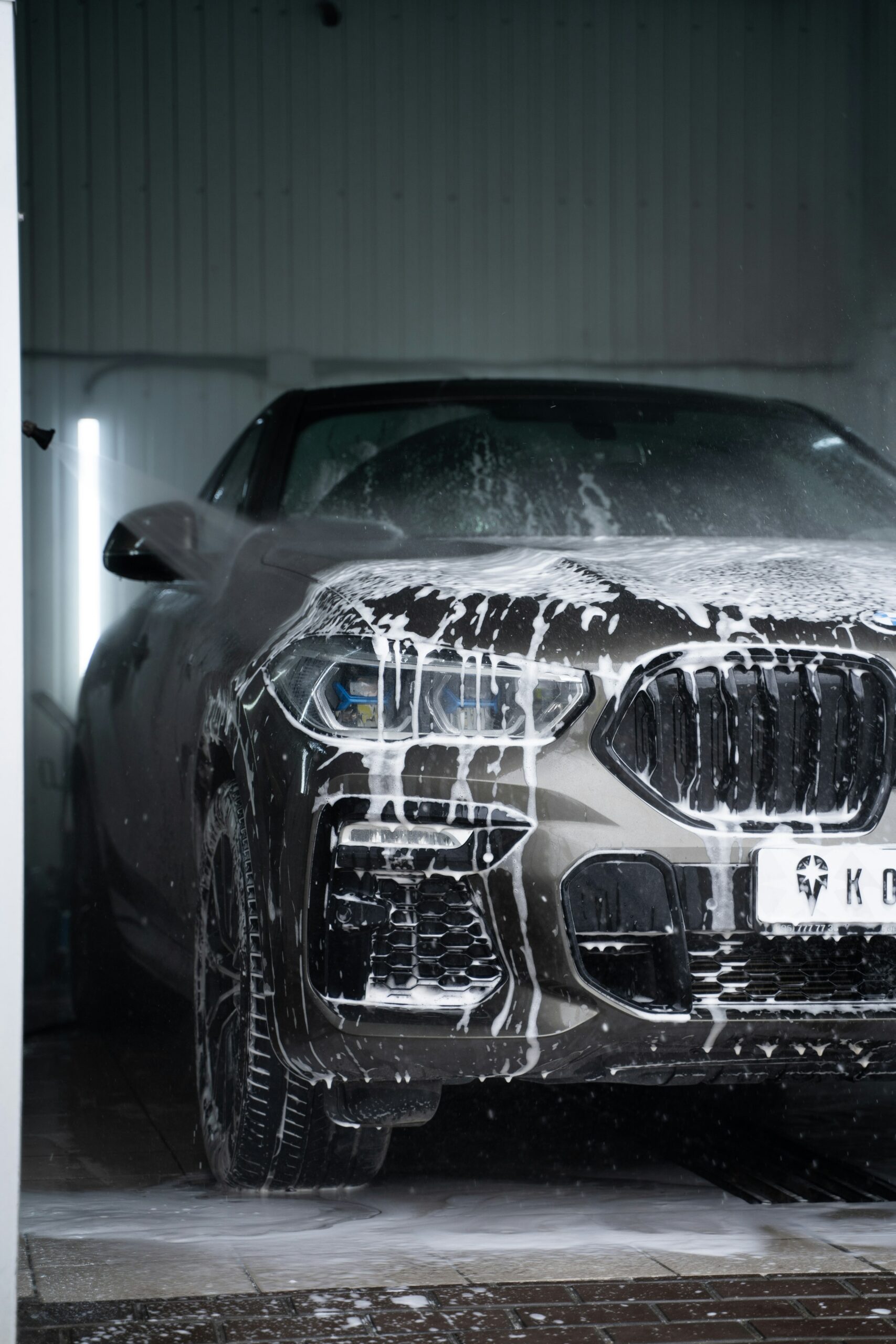 Grey car covered in snow foam
