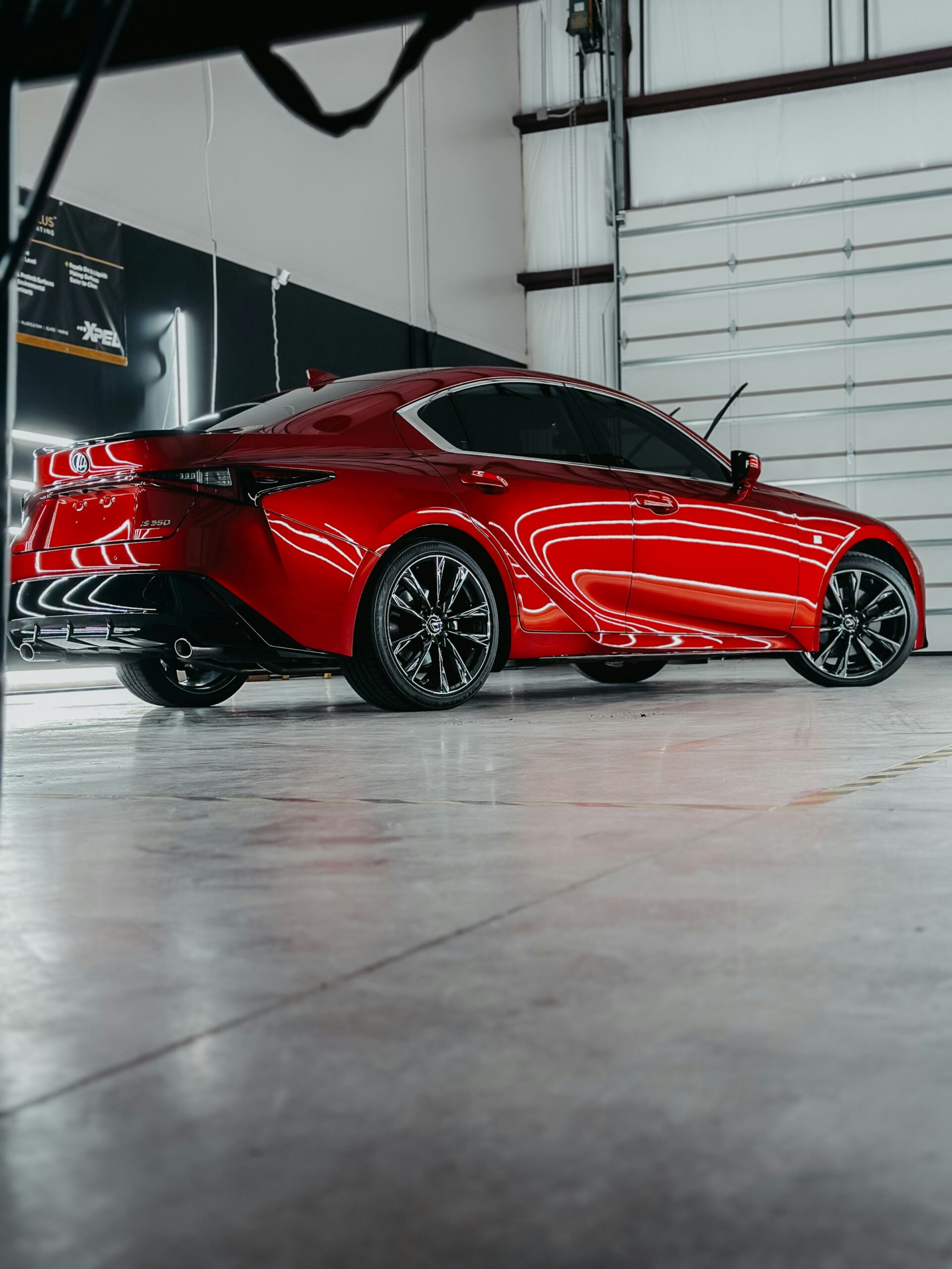 Red sports car inside a detailing garage