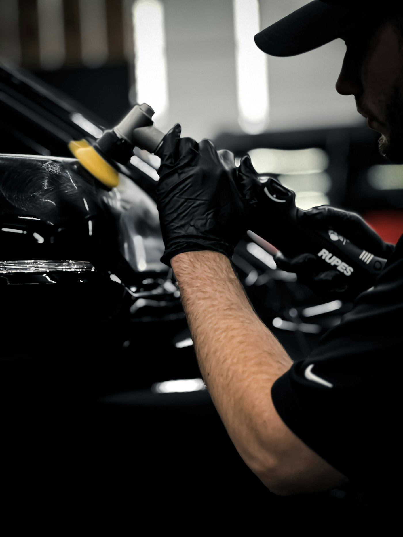 Technician working on a car inside the studio