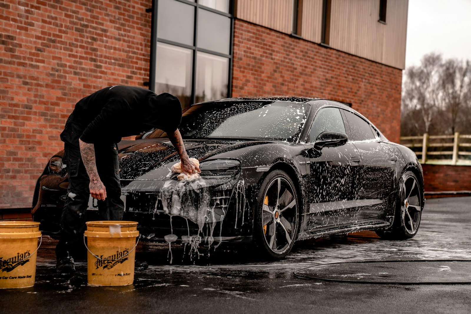 Water splashing across a black coupe